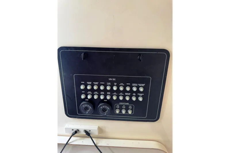 Slide: The Image of Control panel of 2024 Boston Whaler 280 Outrage boat, featuring various switches and outlets. - 15