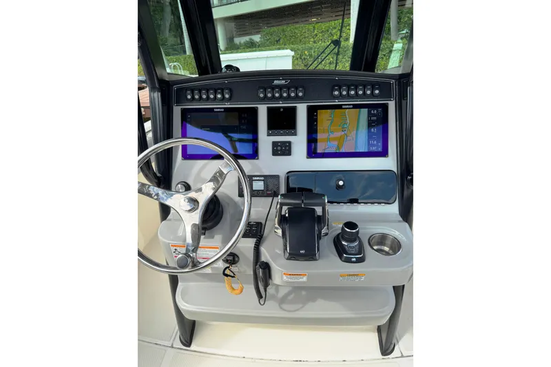 Slide: The Image of 2024 Boston Whaler 280 Outrage helm with advanced navigation displays and controls. - 17