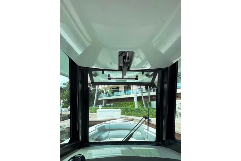 Slide: The Image of 2024 Boston Whaler 280 Outrage boat interior view with windshield and console. - 20