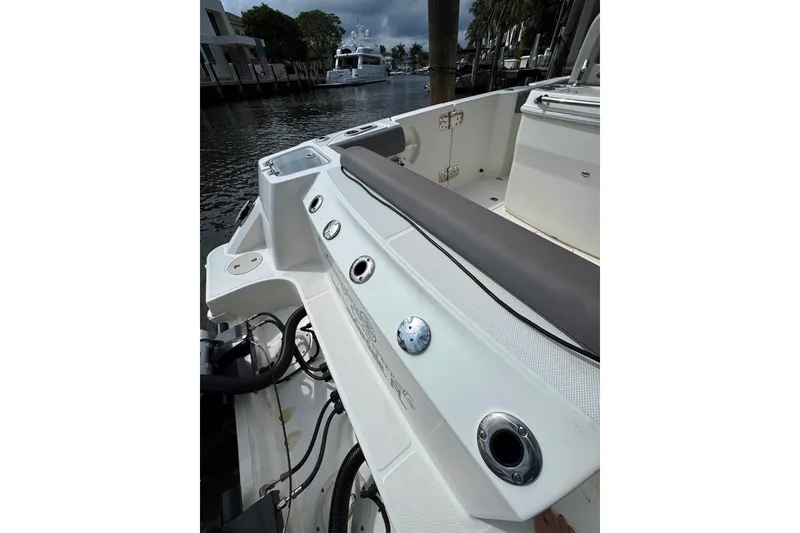 Slide: The Image of 2024 Boston Whaler 280 Outrage boat interior with seating and rod holders. - 25