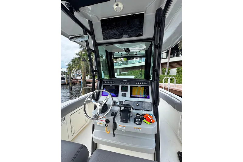 Slide: The Image of 2024 Boston Whaler 280 Outrage helm with advanced navigation systems and sleek design. - 5