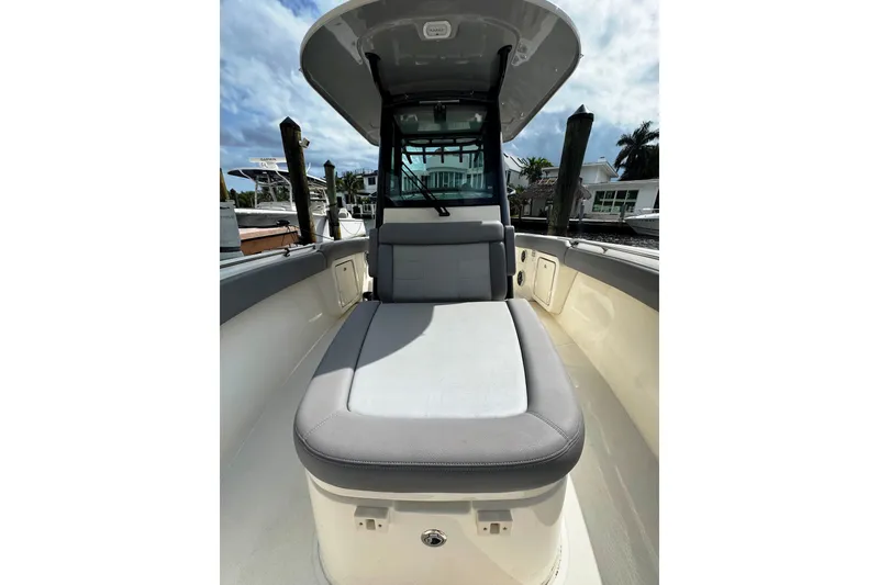 Slide: The Image of 2024 Boston Whaler 280 Outrage boat interior with cushioned seating and sleek design. - 8