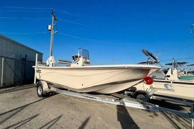 The Image of 2025 Carolina Skiff 19 LS boat on trailer under clear blue sky. - 0