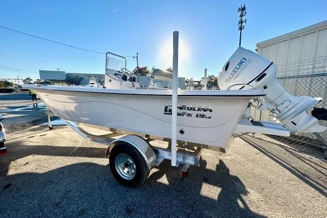 Slide: The Image of 2025 Carolina Skiff 19 LS boat on trailer with Suzuki outboard motor. - 5