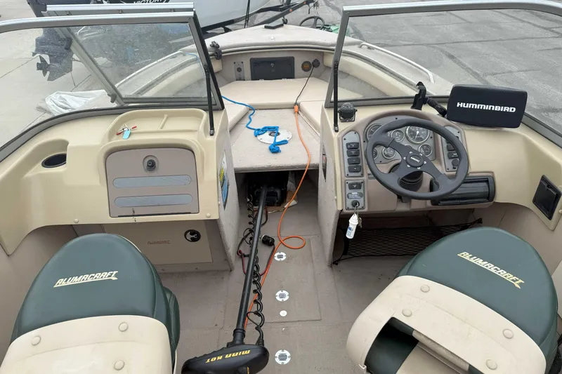 Slide: The Image of 2003 Alumacraft boat interior with steering wheel and Humminbird fish finder. - 3