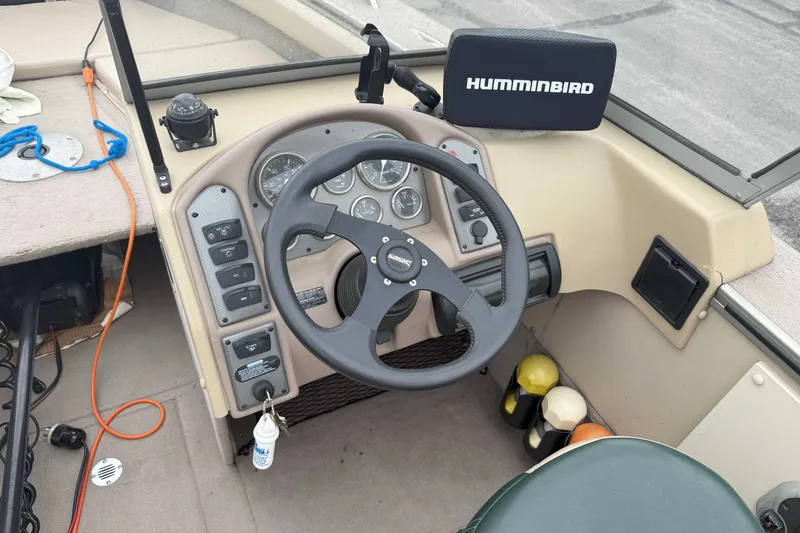 Slide: The Image of 2003 Alumacraft boat dashboard with steering wheel and Humminbird fish finder. - 5