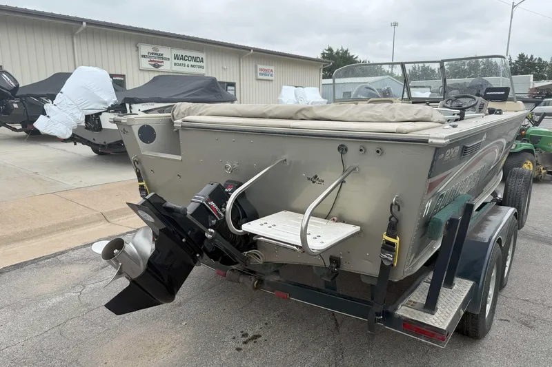 Slide: The Image of 2003 Alumacraft boat on trailer, parked outside Waconda Boats & Motors dealership. - 6