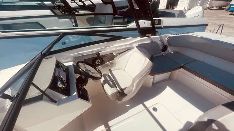 Slide: The Image of Interior of a 2020 Sea Ray 21 SPX-OB boat with steering wheel and seating. - 21