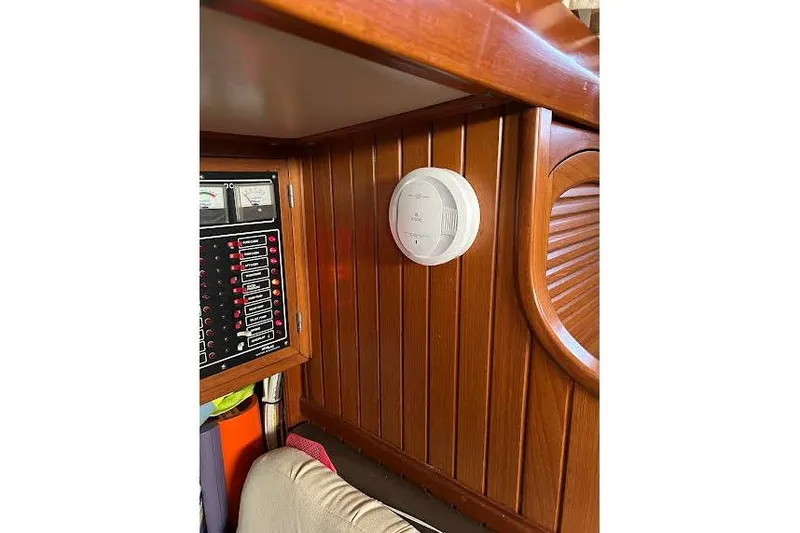 Slide: The Image of Wooden interior of 1984 Slocum 43 yacht with smoke detector and control panel. - 13