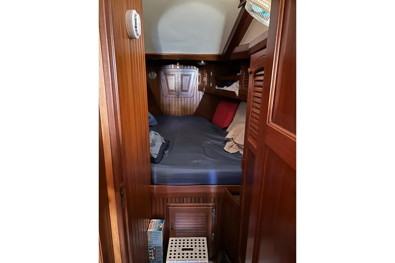 Slide: The Image of Cozy cabin interior of 1984 Slocum 43 sailboat with wooden paneling and bedding. - 20