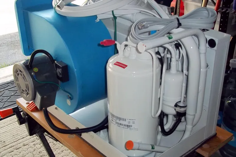 Slide: The Image of Marine air conditioning unit for a 1984 Slocum 43 sailboat, featuring white and blue components. - 24