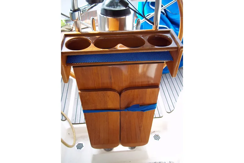 Slide: The Image of Wooden helm console with cup holders on a 1984 Slocum 43 sailboat. - 3