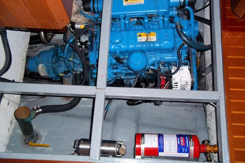 Slide: The Image of Engine compartment of a 1984 Slocum 43 sailboat, featuring a blue marine engine. - 6