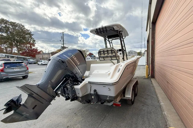 Slide: The Image of 2022 Key West 239 FS boat with Yamaha outboard motor parked near a building. - 1