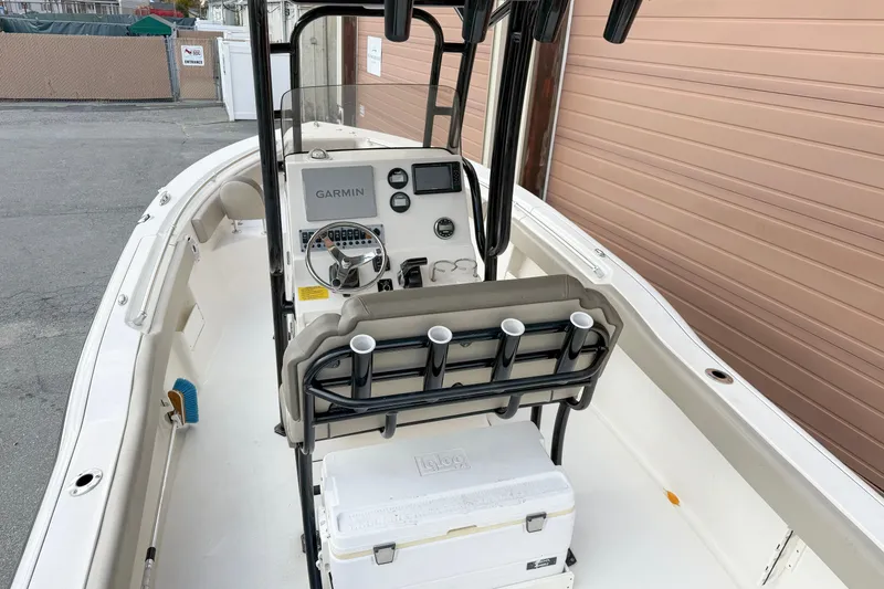 Slide: The Image of 2022 Key West 239 FS boat interior with Garmin navigation system and seating. - 2