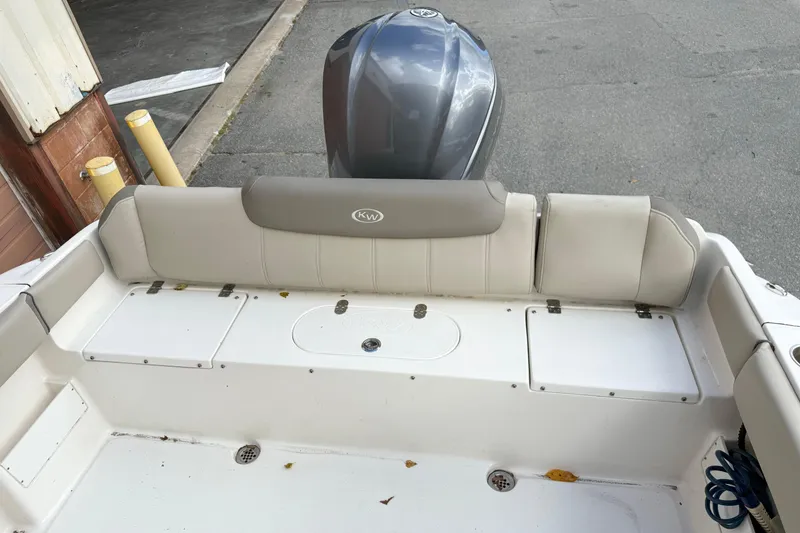 Slide: The Image of 2022 Key West 239 FS boat interior with cushioned seating and storage compartments. - 4