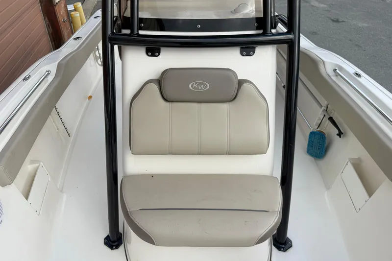 Slide: The Image of 2022 Key West 239 FS boat interior with beige seating and black frame. - 6
