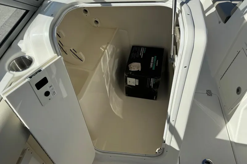 Slide: The Image of Storage compartment of 2025 Key West 239 DFS boat with a box inside. - 13