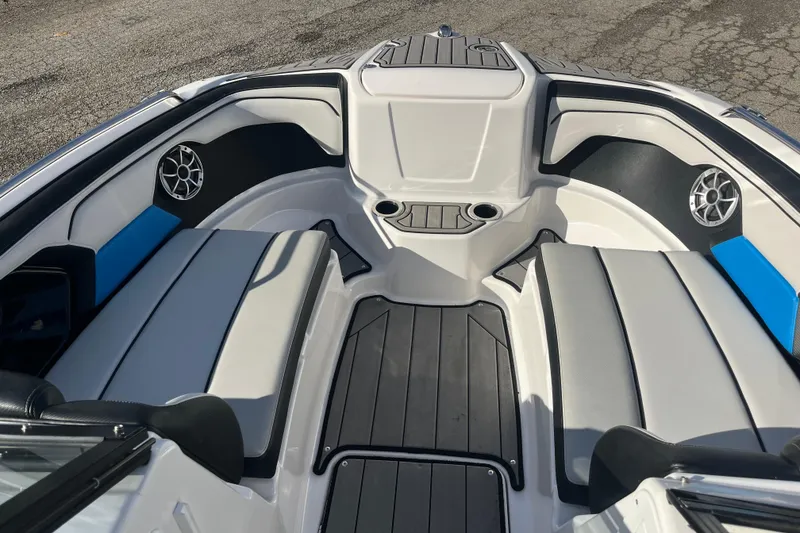 Slide: The Image of 2019 Yamaha Boats 212X interior with seating, cup holders, and speakers. - 4