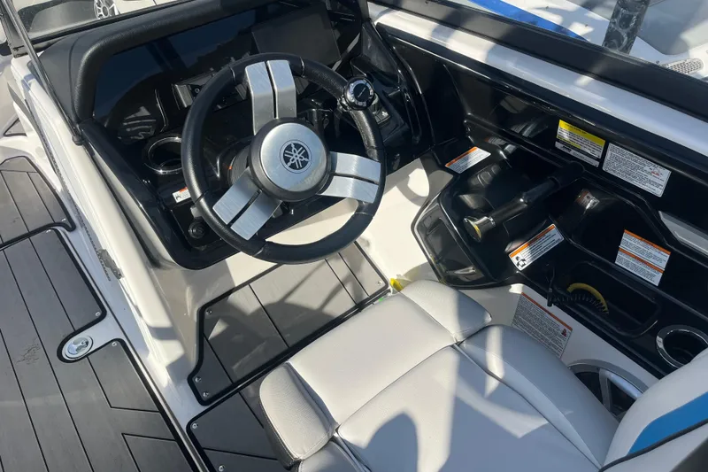 Slide: The Image of 2019 Yamaha Boats 212X cockpit with steering wheel and control panel. - 5