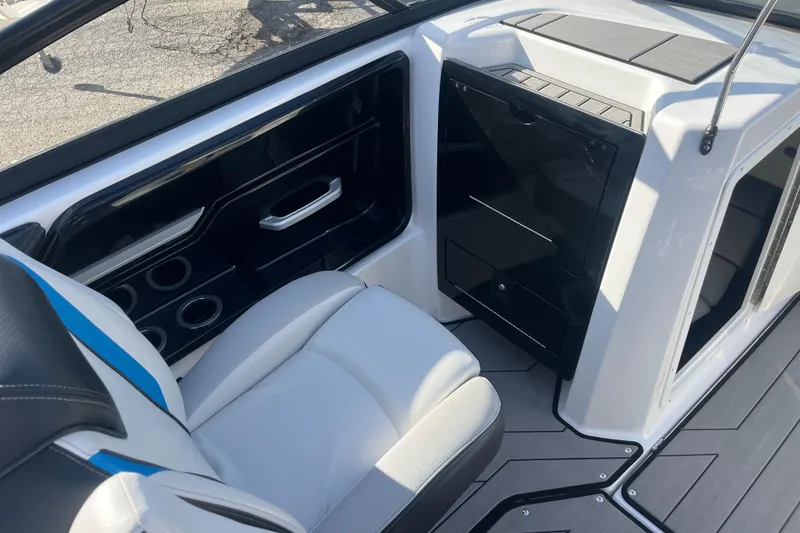 Slide: The Image of Interior of a 2019 Yamaha Boats 212X, featuring sleek seating and storage compartments. - 7