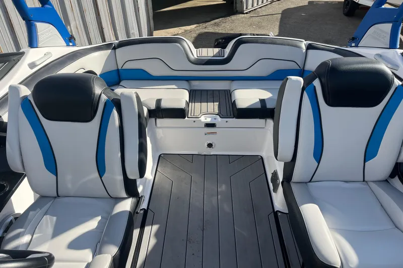 Slide: The Image of 2019 Yamaha Boats 212X interior with blue and white seating, modern design. - 8