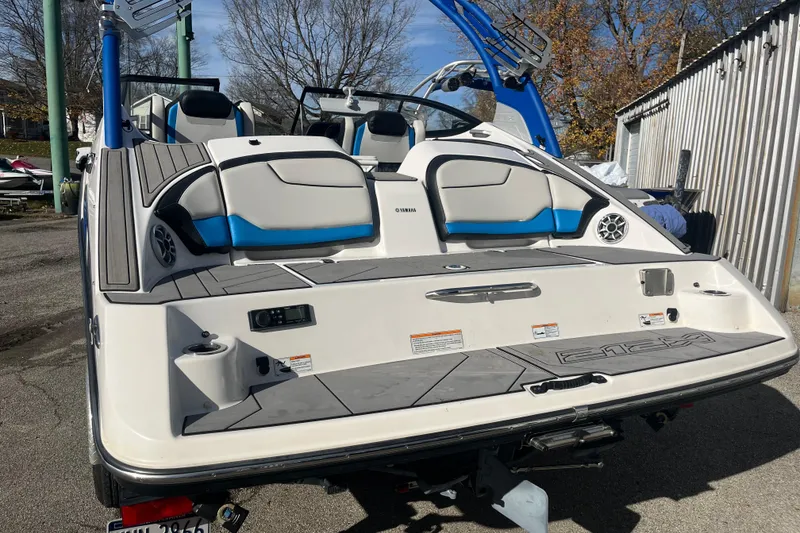 Slide: The Image of 2019 Yamaha Boats 212X, rear view, showcasing sleek design and seating area. - 9