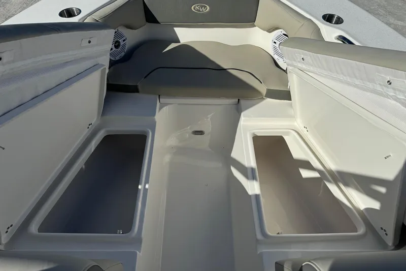 Slide: The Image of 2025 Key West 239 DFS boat interior with open storage compartments and seating. - 11