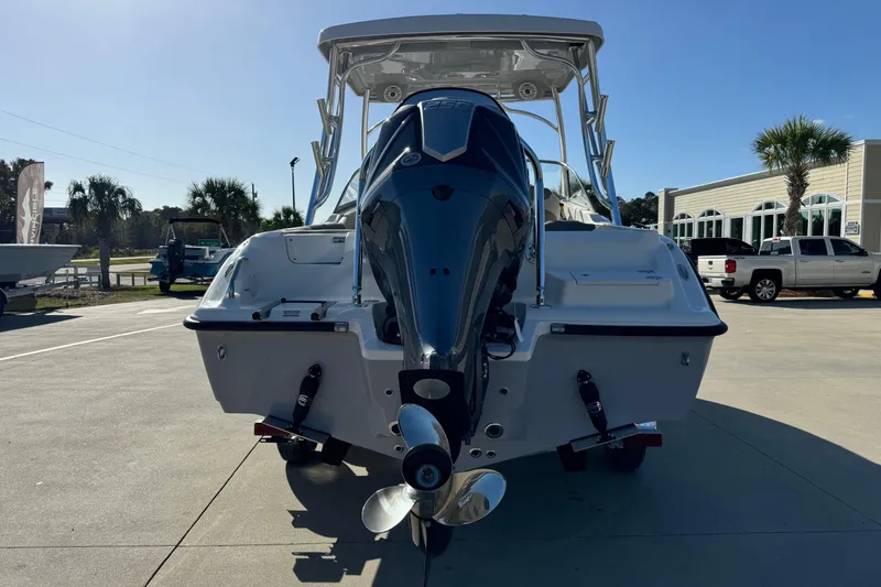 Slide: The Image of 2025 Key West 239 DFS boat with powerful outboard motor, parked outdoors. - 3