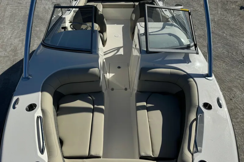 Slide: The Image of 2025 Key West 239 DFS boat interior with beige seating and open windshield. - 8
