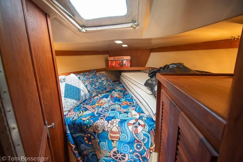 Slide: The Image of Cozy cabin interior of 1984 Catalina 36 sailboat with vibrant bedding and wooden furnishings. - 18