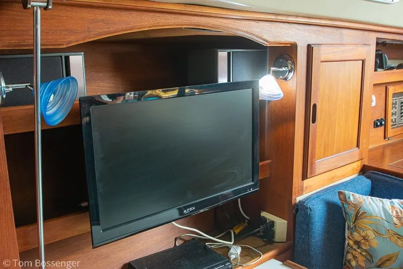 Slide: The Image of Interior of 1984 Catalina 36 yacht with TV and wooden cabinetry. - 21