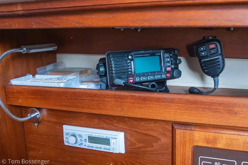 Slide: The Image of 1984 Catalina 36 yacht interior with radio equipment and wooden cabinetry. - 24