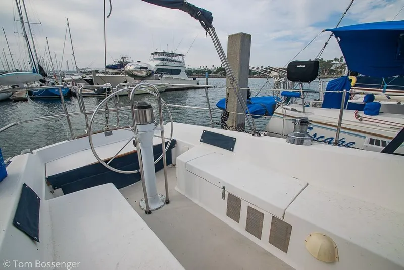 Slide: The Image of 1984 Catalina 36 sailboat cockpit with marina view, featuring steering wheel and seating. - 25