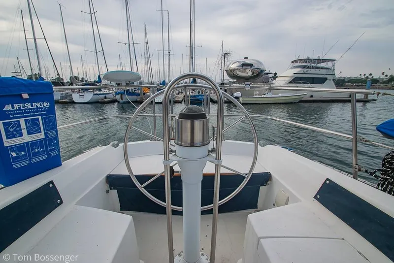 Slide: The Image of Cockpit view of a 1984 Catalina 36 sailboat docked in a marina. - 26