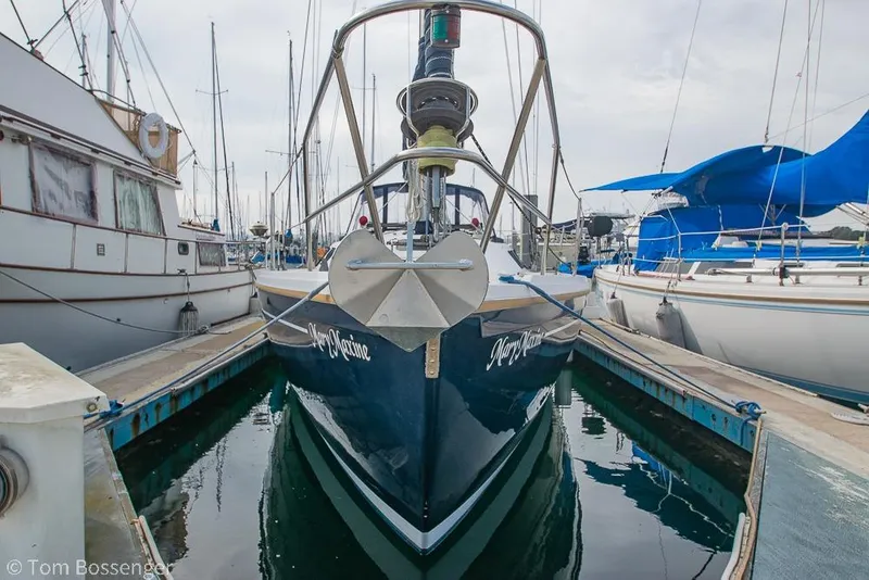 Slide: The Image of 1984 Catalina 36 sailboat docked in marina, front view with anchor. - 3