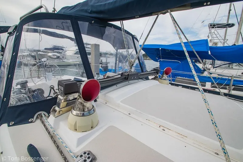 Slide: The Image of 1984 Catalina 36 sailboat cockpit with marina view, featuring nautical equipment and blue canopy. - 32
