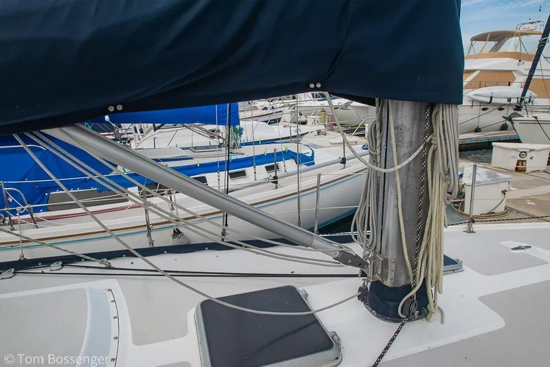 Slide: The Image of 1984 Catalina 36 sailboat mast and rigging in a marina setting. - 33