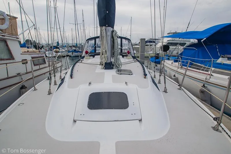 Slide: The Image of 1984 Catalina 36 sailboat docked in a marina, surrounded by other boats. - 35
