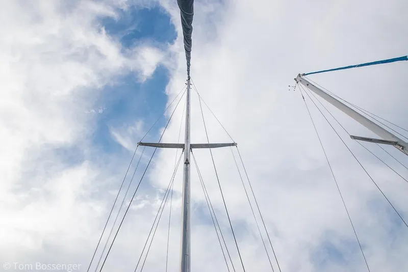 Slide: The Image of Masts of a 1984 Catalina 36 sailboat against a cloudy sky. - 36