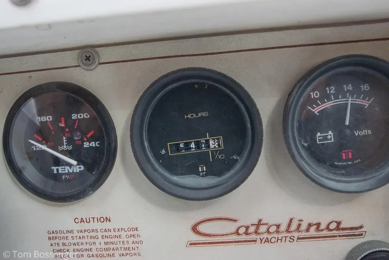 Slide: The Image of Dashboard gauges of a 1984 Catalina 36 yacht, showing temperature, hours, and voltage. - 37