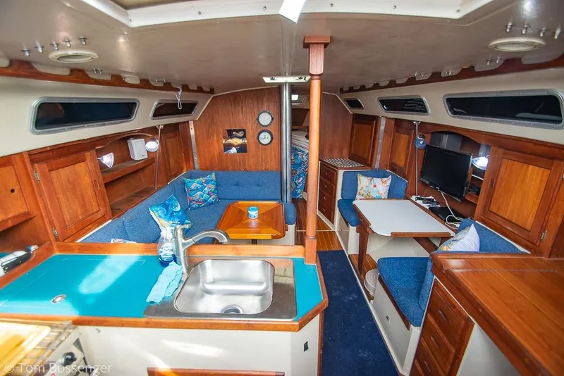 Slide: The Image of Interior of a 1984 Catalina 36 sailboat with cozy seating and wooden cabinetry. - 6