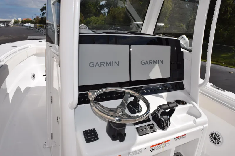 Slide: The Image of 2026 Sea Hunt Ultra 305 Coffin Box boat with dual Garmin displays and steering console. - 10