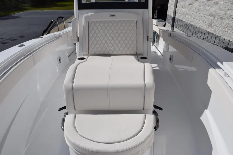 Slide: The Image of 2026 Sea Hunt Ultra 305 Coffin Box boat interior with white cushioned seating. - 14