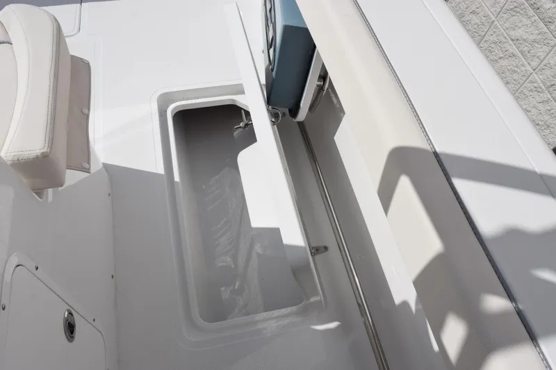 Slide: The Image of 2026 Sea Hunt Ultra 305 Coffin Box interior with open storage compartment. - 22