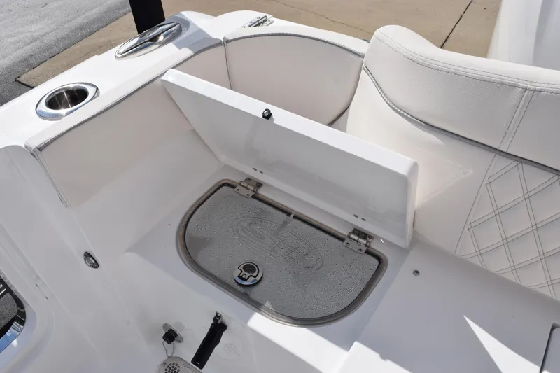 Slide: The Image of 2026 Sea Hunt Ultra 305 Coffin Box interior with storage compartment and cup holders. - 24