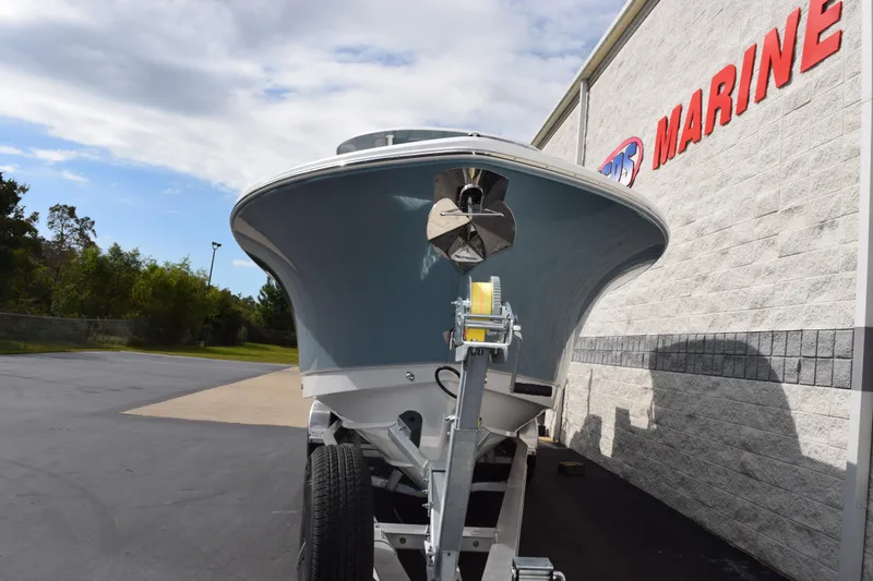 Slide: The Image of 2026 Sea Hunt Ultra 305 Coffin Box boat on trailer, parked near marine store. - 3