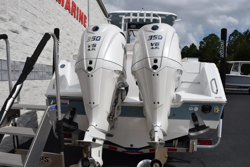 Slide: The Image of 2026 Sea Hunt Ultra 305 Coffin Box with twin 350 V6 engines, docked outdoors. - 5