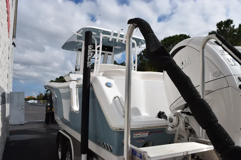 Slide: The Image of 2026 Sea Hunt Ultra 305 Coffin Box boat with Yamaha engine, parked outdoors. - 6