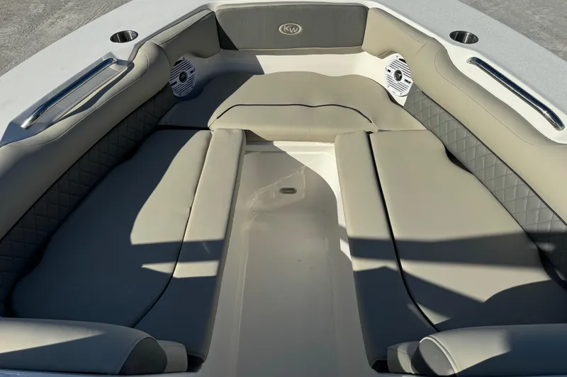 Slide: The Image of 2025 Key West 239 DFS boat interior with cushioned seating and cup holders. - 10